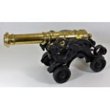 A large decorative brass table cannon with ornate