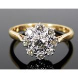 An 18ct gold daisy style ring set with approx. 0.6