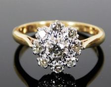 An 18ct gold daisy style ring set with approx. 0.6