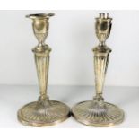 A pair of early 20thC. silver candle holders one l