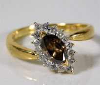 An 18ct gold ring set with marquise cut cinnamon c