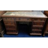 An early 20thC. knee hole desk with nine drawers 4