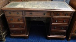 An early 20thC. knee hole desk with nine drawers 4