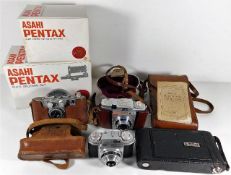 Four vintage cameras including Mercury II Universal & accessories