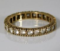 A 9ct gold eternity ring set with paste stones 2.4