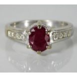 A 9ct white gold ring set with diamonds & ruby 3.9
