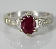 A 9ct white gold ring set with diamonds & ruby 3.9