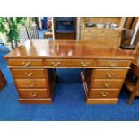 A mahogany partners style pedestal desk 59.5in W x