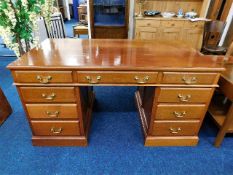 A mahogany partners style pedestal desk 59.5in W x