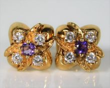 A pair of 9ct gold earrings set with diamond & ame