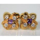 A pair of 9ct gold earrings set with diamond & ame