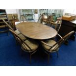 An Ercol mid-oak extending dining table with eight swan back chairs 67in L x 43in W x 29in H
