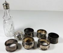 Six silver napkin rings, a silver topped jar & a s