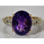 A 9ct gold ring set with diamond & amethyst 2.6g s