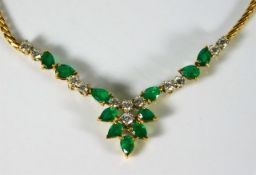 An 18ct gold necklace set with emerald & approx. 0