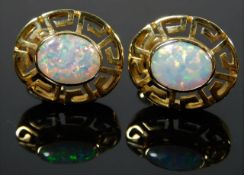 A pair of 14ct gold earrings set with opal style s