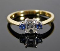 An 18ct gold ring set with 0.5ct emerald cut diamond & sapphire 3.3g size N/O