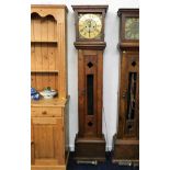 A brass faced longcase clock with rustic arts & cr