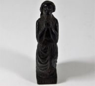 An early carved wooden figure inscribed Ora Pro No