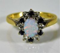 An 18ct gold ring by B. Morris set with approx. 0.18ct diamond, sapphire & opal 3.8g size L