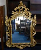 An ornate reproduction gilt framed mirror 50in wid