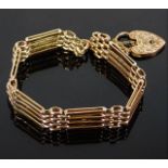 A 9ct gold four bar gate bracelet with engraved cl