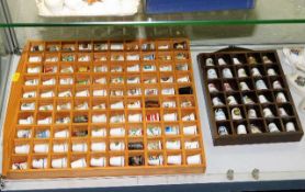 Two trays of mostly porcelain thimbles including D