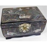 A decorative jewellery box with applied mother of