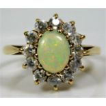 A 9ct gold ring set with opal style stone & paste