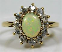 A 9ct gold ring set with opal style stone & paste