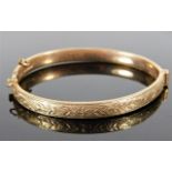 A childs 9ct gold bangle with chased decor 6.2g