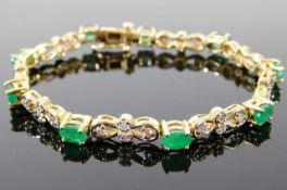 A 14ct gold bracelet set with emeralds & approx. 1