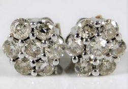 A pair of white metal earrings, test as 18ct gold,