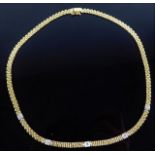 An 18ct gold necklace set with approx. 0.35ct diam