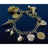 A 9ct gold charm bracelet with eight charms includ