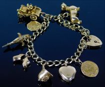 A 9ct gold charm bracelet with eight charms includ