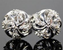 A pair of 9ct white gold earrings set with diamond