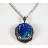 A silver chain & closed back pendant set with opal