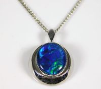 A silver chain & closed back pendant set with opal