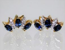 An 18ct gold earrings set with diamond & sapphire