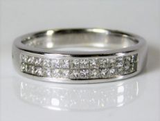 An 18ct white gold half eternity ring set with app