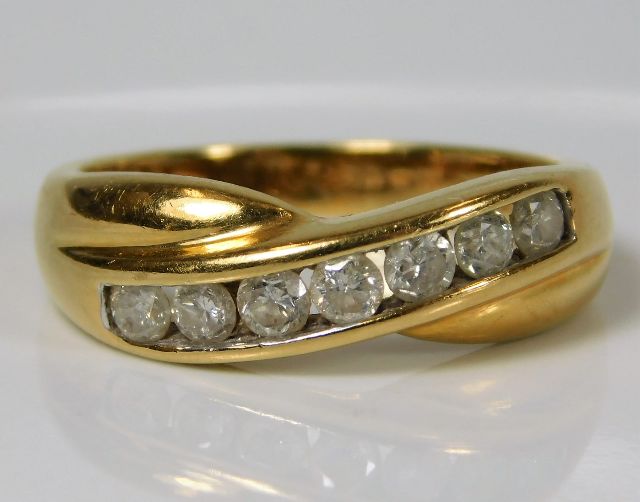 An 18ct gold ring set with seven diamonds of appro