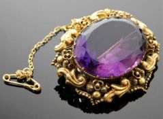 An antique yellow metal brooch set with amethyst 1