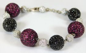 An 18ct white gold bracelet set with rubies, black