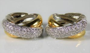 A pair of 18ct two colour gold earrings set with a