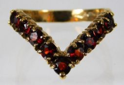 A 9ct gold wishbone ring set with garnet 2.9g size