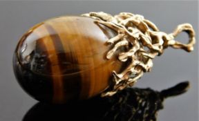 A tiger eye pendant with organic 9ct gold mount 18