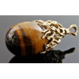 A tiger eye pendant with organic 9ct gold mount 18