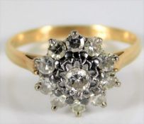 An 18ct gold diamond daisy ring set with approx. 0