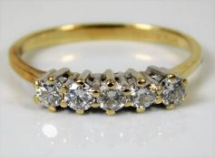 A 14ct gold ring set with five diamonds of approx.